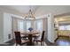 Cozy dining room features an elegant chandelier, round table, and bay window with natural light and shutters at 1311 N Congress Dr, Chandler, AZ 85226