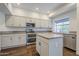 Bright kitchen featuring white cabinets, stainless appliances, and an island workstation at 1311 N Congress Dr, Chandler, AZ 85226