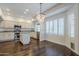 Eat-in kitchen features white cabinets, stainless appliances and decorative lighting at 1311 N Congress Dr, Chandler, AZ 85226
