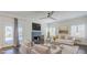 Sophisticated living room with a fireplace, ceiling fan, plush seating, and a mirrored coffee table at 1311 N Congress Dr, Chandler, AZ 85226