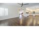 Bright living room featuring wood floors, ceiling fan, and access to a modern kitchen at 1311 N Congress Dr, Chandler, AZ 85226