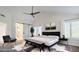 Serene main bedroom with a black tufted headboard, sliding barn door to ensuite, and neutral decor at 1311 N Congress Dr, Chandler, AZ 85226