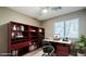 Functional home office with built-in bookshelves, ample storage, a desk, and a bright window at 1311 N Congress Dr, Chandler, AZ 85226