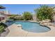 Inviting backyard pool with rock accents, mature landscaping, and a tranquil waterfall feature at 1311 N Congress Dr, Chandler, AZ 85226