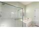 Bathroom featuring a glass-enclosed shower, a soaking tub, and plenty of natural light at 1312 W Bartlett Way, Chandler, AZ 85248