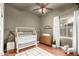 Charming bedroom designed as a Bedroom with hardwood floors, a crib and cheerful decor at 1312 W Bartlett Way, Chandler, AZ 85248