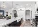 Bright, airy kitchen with a large center island, stainless steel appliances, pendant lights and white cabinets at 1312 W Bartlett Way, Chandler, AZ 85248