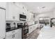 Bright kitchen with stainless steel appliances, subway tile backsplash, table near a window and white cabinets at 1312 W Bartlett Way, Chandler, AZ 85248