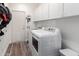 Well-organized laundry room with modern washer and dryer, complemented by ample storage cabinets at 1312 W Bartlett Way, Chandler, AZ 85248