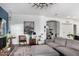 Bright living room featuring an elegant chair, modern artwork, and open archway at 1312 W Bartlett Way, Chandler, AZ 85248