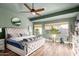 Light-filled main bedroom with stylish wood laminate flooring, ceiling fan and ample natural light at 1312 W Bartlett Way, Chandler, AZ 85248