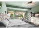 Spacious main bedroom with soothing green walls, large windows, and plush carpeting at 1312 W Bartlett Way, Chandler, AZ 85248