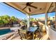 Covered patio area with outdoor dining table and chairs, perfect for entertaining at 1312 W Bartlett Way, Chandler, AZ 85248