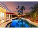 Backyard pool featuring an umbrella, palm trees, and decorative lighting at 1312 W Bartlett Way, Chandler, AZ 85248