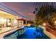 Backyard pool featuring lights, palm trees, and a covered patio at 1312 W Bartlett Way, Chandler, AZ 85248