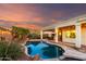 Backyard pool with lush landscaping, patio, and evening sky at 1312 W Bartlett Way, Chandler, AZ 85248