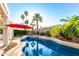 Backyard featuring a beautiful pool and spa with lush landscaping and palm trees at 1312 W Bartlett Way, Chandler, AZ 85248