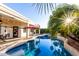 A tranquil pool area showcasing a refreshing swimming pool with nearby lounge seating and lush tropical landscaping at 1312 W Bartlett Way, Chandler, AZ 85248