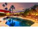 Backyard pool featuring lights, palm trees, and colorful sky at 1312 W Bartlett Way, Chandler, AZ 85248