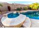 Backyard featuring a spa with lush landscaping and pavers at 1312 W Bartlett Way, Chandler, AZ 85248