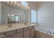 Well-lit bathroom with dual sinks, a soaking tub, and a glass-enclosed shower at 14806 E Lookout Ledge --, Fountain Hills, AZ 85268