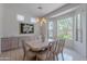 Light-filled dining room with elegant chandelier, large windows, and built-in cabinetry for storage at 14806 E Lookout Ledge --, Fountain Hills, AZ 85268