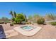 Desert backyard featuring a hot tub, barbecue, rock landscaping, and mountain views at 14806 E Lookout Ledge --, Fountain Hills, AZ 85268