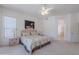 Comfortable main bedroom with soft carpeting, ceiling fan and a glimpse of the ensuite bathroom at 14806 E Lookout Ledge --, Fountain Hills, AZ 85268