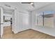 Bright bedroom with large closet, ceiling fan, and view into the kitchen at 15435 N 28Th St # 3, Phoenix, AZ 85032