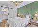 Bright bedroom with modern ceiling fan, accent wall, and bathroom access at 15435 N 28Th St # 3, Phoenix, AZ 85032