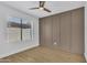 Empty bedroom featuring a ceiling fan, light wood floors, and a stylish accent wall at 15435 N 28Th St # 3, Phoenix, AZ 85032