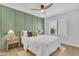 Comfortable bedroom featuring stylish green accent wall, ceiling fan, and natural light at 15435 N 28Th St # 3, Phoenix, AZ 85032