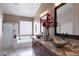 Beautiful main bathroom features dual sinks, granite counters, a soaking tub, and separate shower at 17541 W Statler Dr, Surprise, AZ 85388
