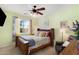 Cozy bedroom with a ceiling fan, a queen-size bed, and natural light from the window at 17541 W Statler Dr, Surprise, AZ 85388