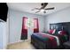Comfortable bedroom featuring a dark wood bed frame and red accents at 17541 W Statler Dr, Surprise, AZ 85388