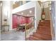 Spacious dining room with elegant lighting, comfortable seating, and eye-catching red accent wall at 17541 W Statler Dr, Surprise, AZ 85388