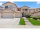 Charming two-story home featuring a spacious driveway, a well-manicured lawn, and a welcoming entrance walkway at 17541 W Statler Dr, Surprise, AZ 85388