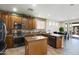 Beautiful kitchen featuring stainless appliances, granite counters, mosaic backsplash, and island with breakfast bar at 17541 W Statler Dr, Surprise, AZ 85388