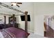 Spacious main bedroom with a four poster bed, TV, and access to an ensuite bath at 17541 W Statler Dr, Surprise, AZ 85388