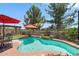 Inviting backyard oasis features a sparkling pool, lush landscaping, and cozy pergola with string lights at 17541 W Statler Dr, Surprise, AZ 85388