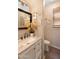 Chic powder room featuring a marble countertop, decorative accents, and a sleek sink at 17541 W Statler Dr, Surprise, AZ 85388