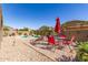Outdoor dining and lounging area near a sparkling pool, perfect for entertaining or relaxing at 17753 W Columbine Dr, Surprise, AZ 85388