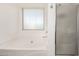 Bright bathroom with a soaking tub and a separate shower at 17753 W Columbine Dr, Surprise, AZ 85388
