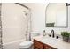 Bright bathroom features a shower and tub combo, vanity with sink, and modern fixtures at 17753 W Columbine Dr, Surprise, AZ 85388