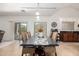 Open-concept dining area with large table, wicker chairs, and sliding door to the patio at 17753 W Columbine Dr, Surprise, AZ 85388