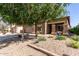 Charming two-story home with a large driveway, desert landscaping, and stone accents on the facade at 17753 W Columbine Dr, Surprise, AZ 85388