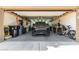 Spacious garage interior with plenty of storage and an SUV parked in the middle, featuring overhead lighting at 17753 W Columbine Dr, Surprise, AZ 85388