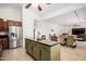 Well-lit kitchen with island, stainless steel appliances, and open layout to the dining area at 17753 W Columbine Dr, Surprise, AZ 85388