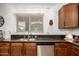 Kitchen features stainless steel sink, granite counters, and wooden cabinetry at 17753 W Columbine Dr, Surprise, AZ 85388
