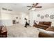 Large open living room with exercise equipment, seating, and study nook at 17753 W Columbine Dr, Surprise, AZ 85388